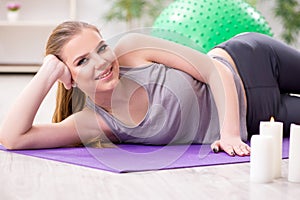 The young woman exercising with stability ball in gym