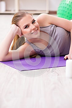 The young woman exercising with stability ball in gym