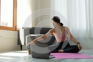 Young woman is exercising yoga at home. Fitness, workout, healthy living and diet concept