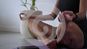 Young woman exercising on yoga mat at daytime