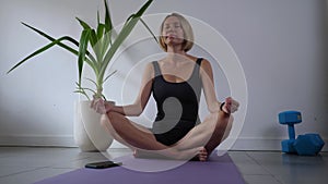 Young woman exercising on yoga mat at daytime