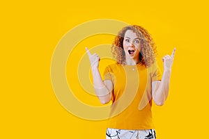 Young woman exhilarated by discovery over yellow background