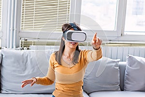 Young woman experiencing immersive virtual reality technology wearing VR glasses, interacting with 360 degrees headset user