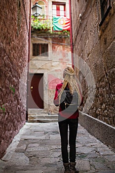 Young woman explores old portugese town