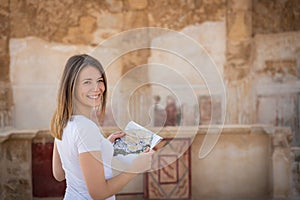 Young woman exploring the ruins of masada in israel