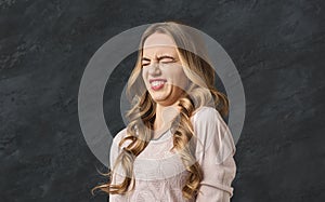 Young woman expressing disgust, grimacing