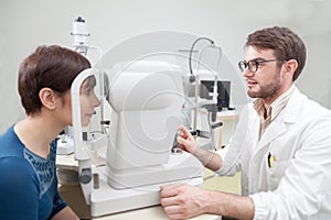 Young woman is during an eye exam with the ophthalmologist
