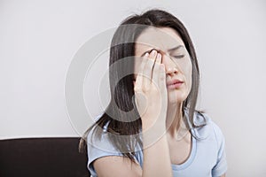 Young woman with eye fatigue