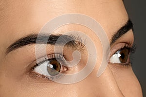 Young woman after eyelash lamination, closeup. Professional service