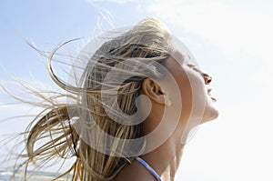 Young Woman With Eyes Closed Enjoying Sunlight