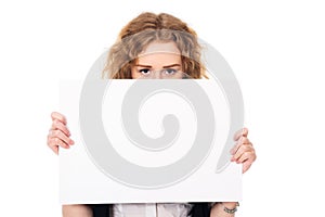 Young woman eyes over a blank promotional display isolated on a