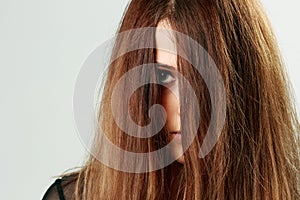 Young woman face covered with hair photo