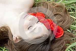 Young woman face in flowers