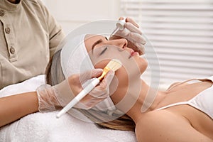 Young woman during face peeling procedure