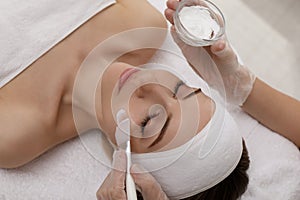 Young woman during face peeling procedure