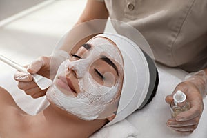 Young woman during face peeling procedure