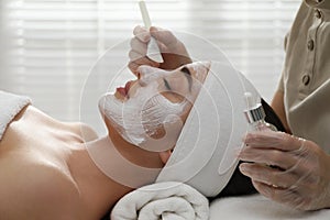 Young woman during face peeling procedure