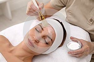 Young woman during face peeling in salon