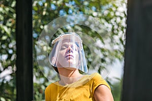 young woman with face visor during covid-19 pandemic