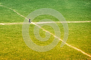 A young woman faces a choice at a fork in the road. The girl at the crossroads of two paths, the view from the top