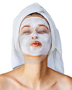 Young woman with facial mask on her face. Skin care and treatment, spa, natural beauty and cosmetology concept, isolated over