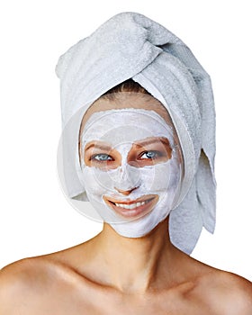 Young woman with facial mask on her face. Skin care and treatment, spa, natural beauty and cosmetology concept, isolated over