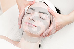 Young woman facial massage in beauty parlour photo