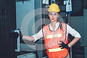 Young woman factory worker close up portrait in manufacturing job factory