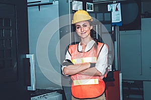 Young woman factory worker close up portrait in manufacturing job factory