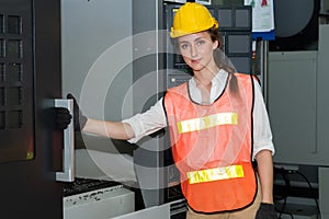 Young woman factory worker close up portrait in manufacturing job factory