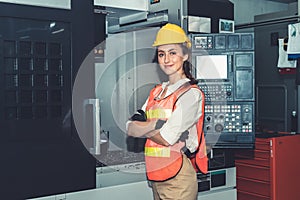 Young woman factory worker close up portrait in manufacturing job factory