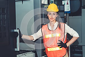 Young woman factory worker close up portrait in manufacturing job factory