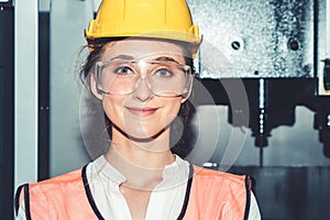 Young woman factory worker close up portrait in manufacturing job factory