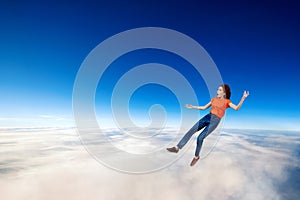 Young woman failed and falling down in clouds sea.