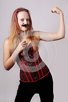 Young woman with fake moustache