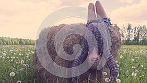 Young woman falling down from haystack