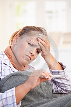 Young woman feeling bad taking her temperature