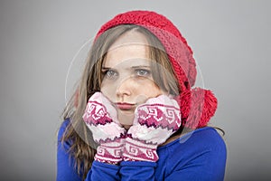 Young woman feeling cold trying to keep warm, shaking and shiver