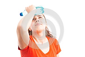 Young woman feeling hot and cooling with water bottle