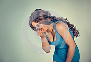 Young woman feeling nauseated about to vomit
