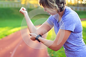 Young woman feeling pain in her elbow during sport workout at st