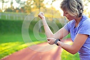 Young woman feeling pain in her elbow during sport workout at st