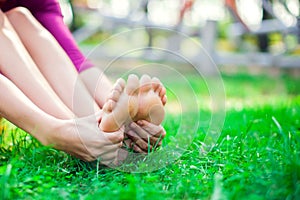 Young woman feeling pain in her foot during sport workout in the