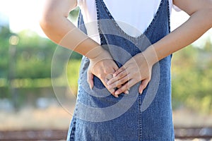 Young woman feeling pain with low back pain on nature green background, Healthcare and Medicine concep