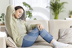 Young woman feeling pain rubbing tensed muscles. Stiff neck, neck strain concept