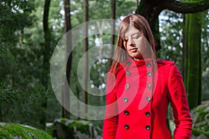 Young woman feeling sad and depressed walking on a forest