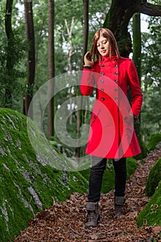 Young woman feeling sad walking on a forest
