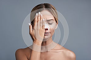 Young woman feeling terrible and closing her eye