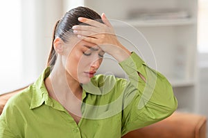 Young Woman Feeling Unwell With a Headache at Home