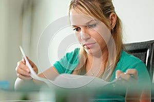 Young woman female student studying at home